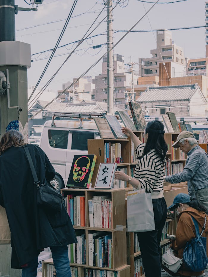 services-01 Shoppers browse books at Nagoyas outdoor book market on a sunny day.