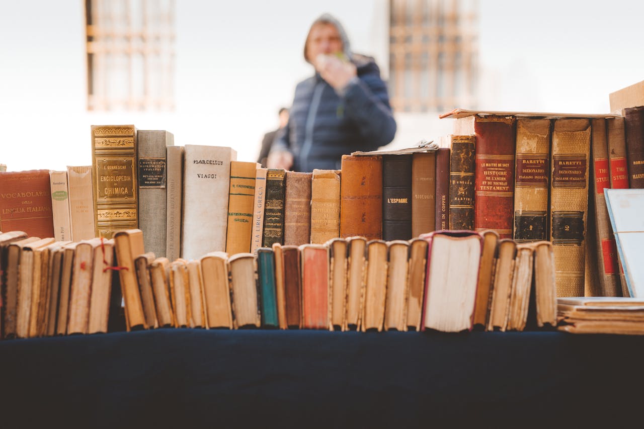 story-img A collection of vintage books on display at an outdoor market in Rovereto, Italy.