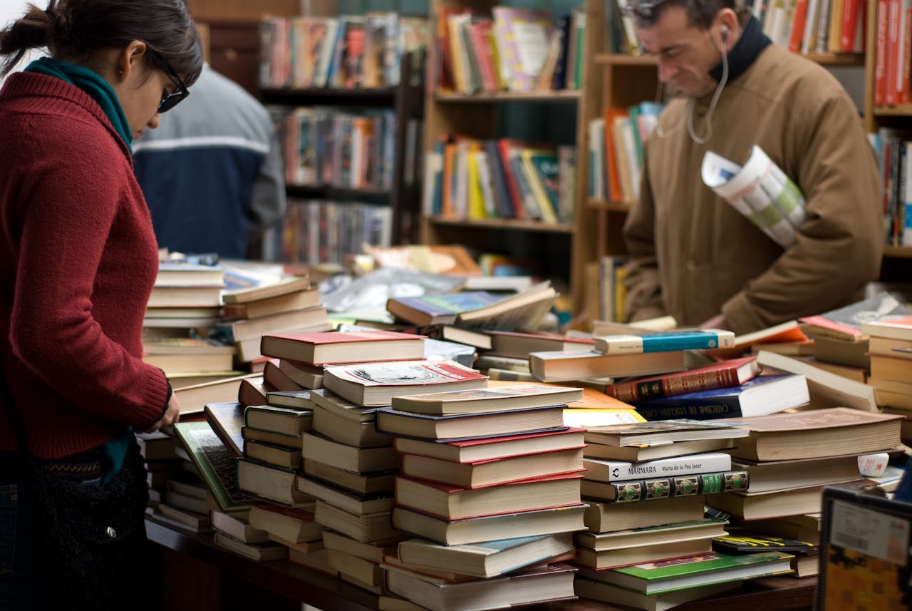 mission-img People browsing a large selection of books at a bookstore or market.